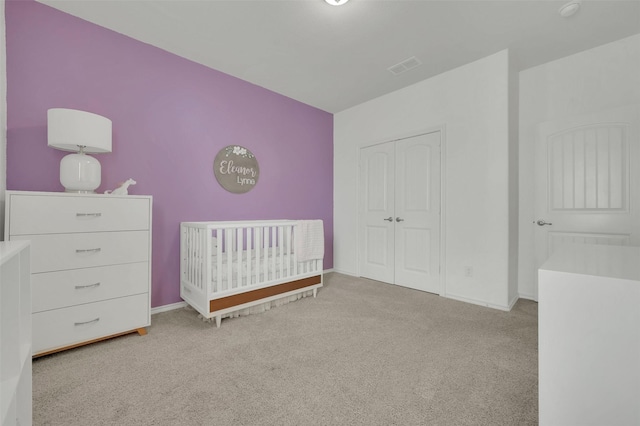 unfurnished bedroom featuring carpet, a closet, visible vents, and baseboards