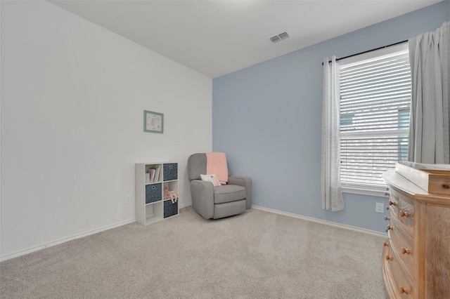 sitting room with carpet floors, visible vents, and baseboards