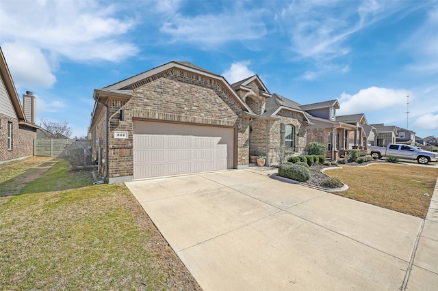 view of front of home featuring a garage, brick siding, driveway, a residential view, and a front lawn