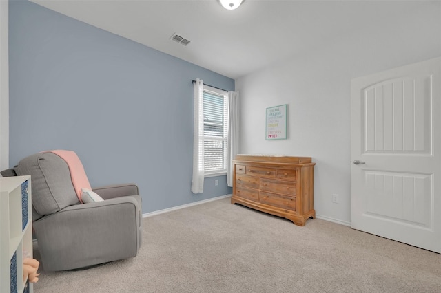 living area with carpet, visible vents, and baseboards