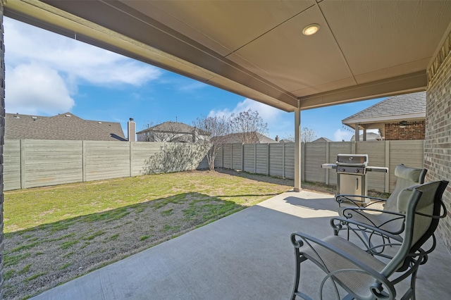 view of patio with a fenced backyard and a grill