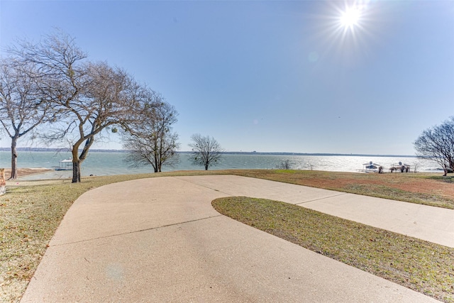 view of community featuring a yard and a water view