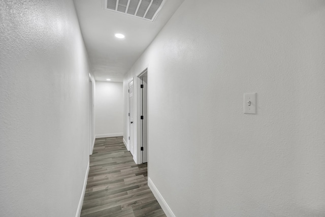 corridor with dark hardwood / wood-style floors