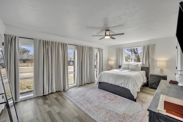 bedroom with light wood-type flooring and ceiling fan