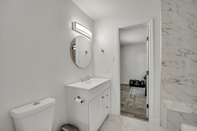 bathroom featuring vanity, toilet, and walk in shower