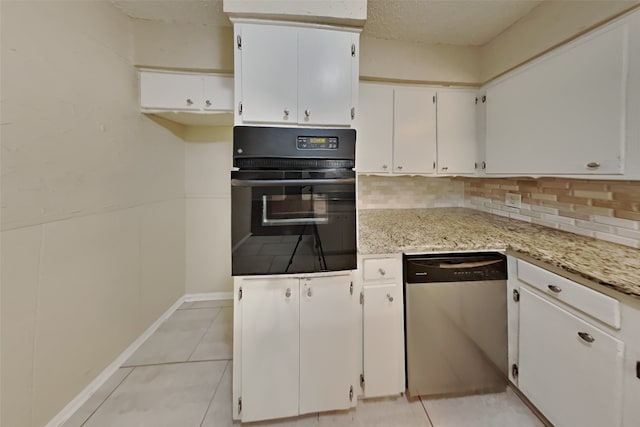 kitchen with dishwasher, oven, light stone countertops, and white cabinets