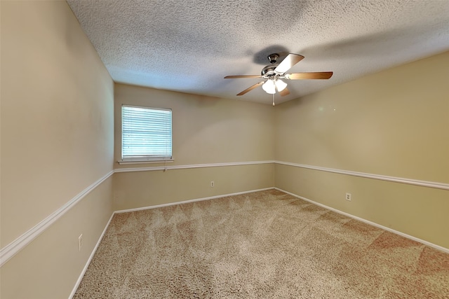 carpeted spare room with ceiling fan and a textured ceiling