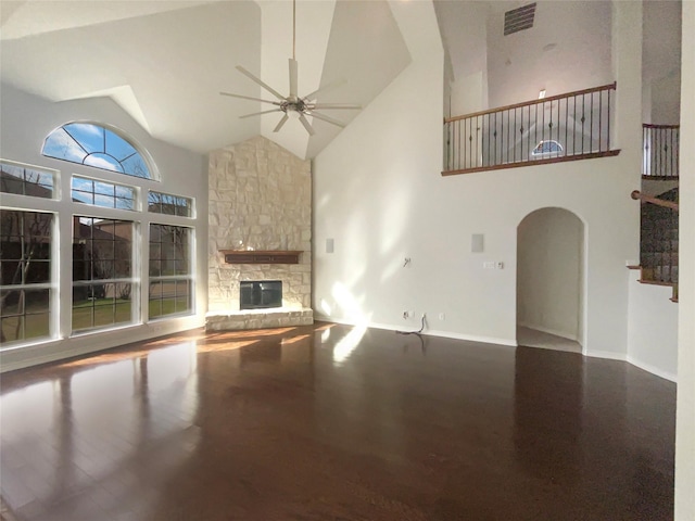 unfurnished living room featuring high vaulted ceiling, ceiling fan, and a fireplace