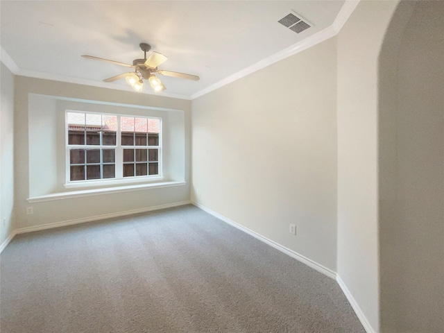 carpeted empty room with ceiling fan and crown molding