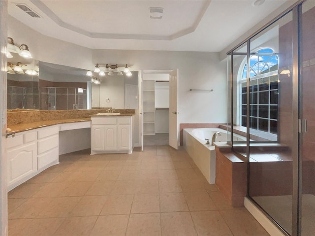 bathroom featuring vanity, tile patterned flooring, independent shower and bath, and a raised ceiling