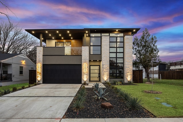 modern home featuring a garage and a lawn