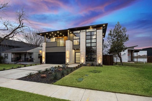 contemporary home featuring a yard and a garage