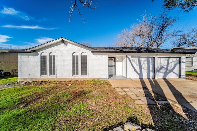 ranch-style home with a front yard and a garage