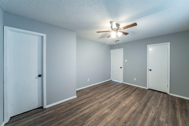 unfurnished bedroom with ceiling fan, dark hardwood / wood-style floors, and a textured ceiling