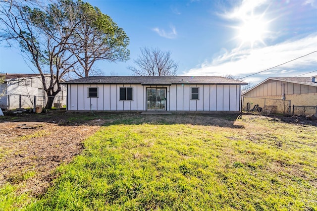 rear view of house featuring a lawn