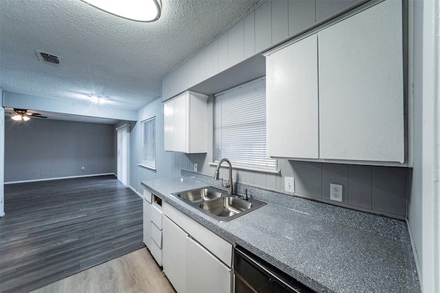 kitchen with hardwood / wood-style flooring, a textured ceiling, white cabinets, ceiling fan, and sink