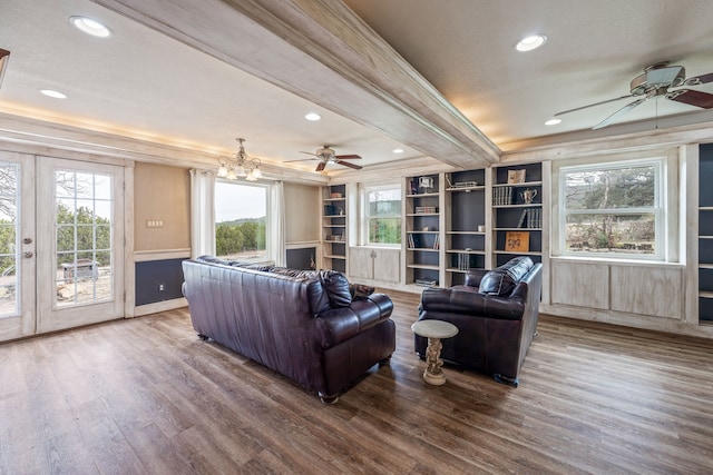 living room featuring wood-type flooring, ceiling fan, french doors, ornamental molding, and beam ceiling