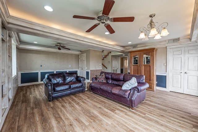 living room featuring ornamental molding, hardwood / wood-style flooring, and a chandelier