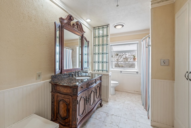 bathroom featuring vanity, crown molding, and toilet