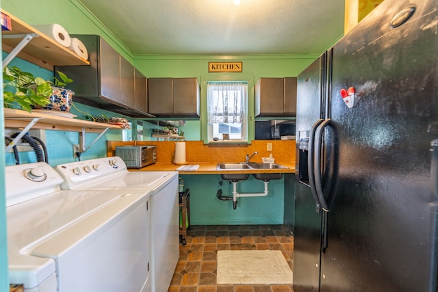 clothes washing area with washer and dryer, cabinets, sink, and ornamental molding