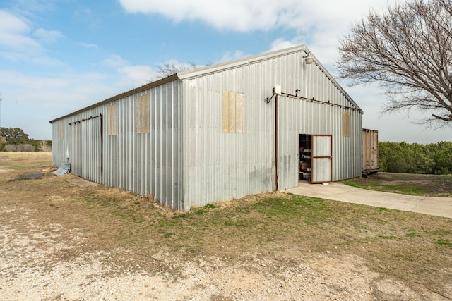 view of outdoor structure featuring a lawn