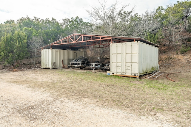 view of outbuilding featuring a lawn