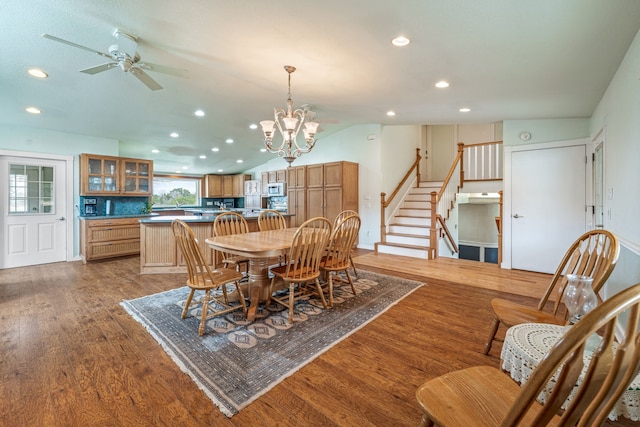 dining area featuring vaulted ceiling, dark hardwood / wood-style floors, and ceiling fan