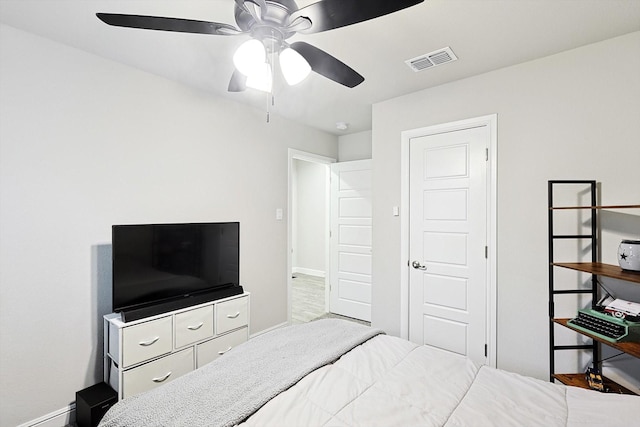 bedroom with a ceiling fan, visible vents, and baseboards