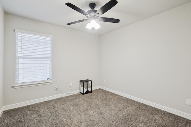 spare room featuring carpet floors, ceiling fan, and baseboards