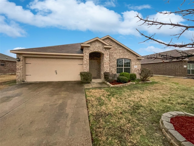 view of front of house with an attached garage, brick siding, concrete driveway, and a front yard