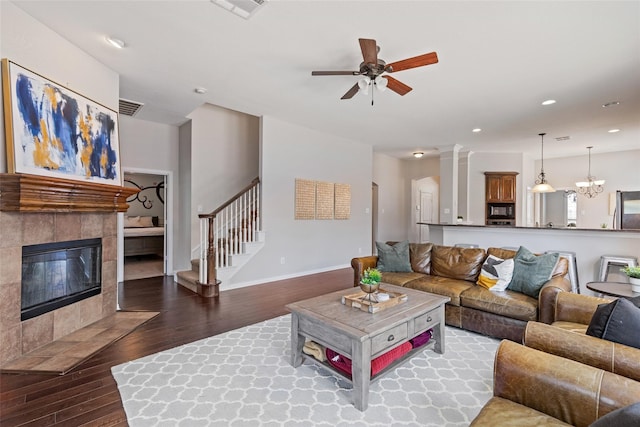 7621 Glenwood Springs Ln, Mckinney, TX 75070 - living area with wood finished floors, ceiling fan, stairs, baseboards, and a fireplace