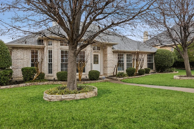 ranch-style home featuring a front yard