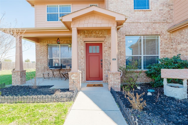 view of exterior entry with brick siding