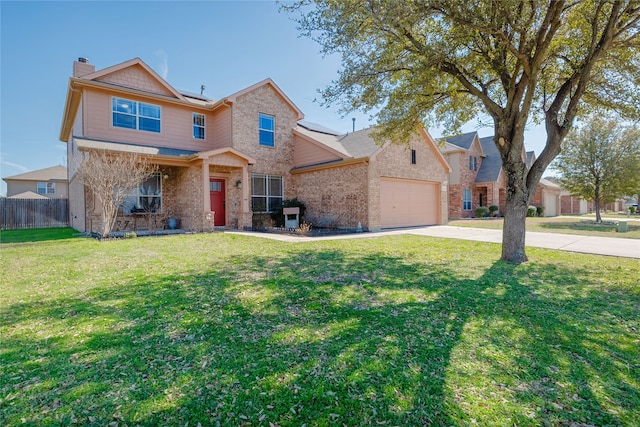 traditional home with fence, driveway, a garage, brick siding, and a front yard