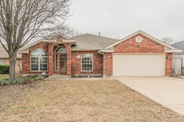 view of front facade featuring concrete driveway, roof with shingles, an attached garage, a front lawn, and brick siding