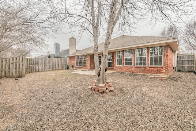 back of property with a patio