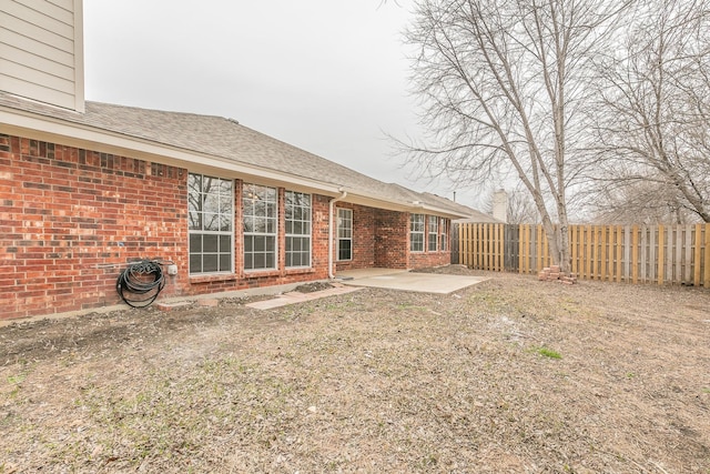 rear view of property with a patio and a lawn