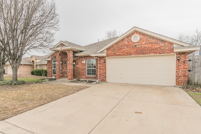 view of front of house featuring driveway, roof with shingles, a garage, and brick siding