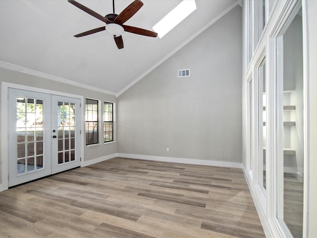 spare room featuring light wood-type flooring, french doors, crown molding, and ceiling fan