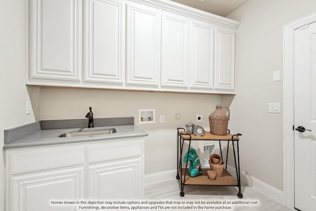 laundry room featuring hookup for a washing machine, sink, and cabinets