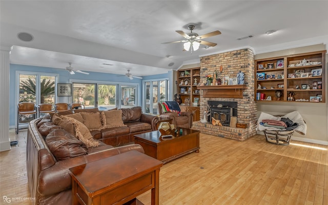 living room featuring light hardwood / wood-style flooring, ceiling fan, and built in features