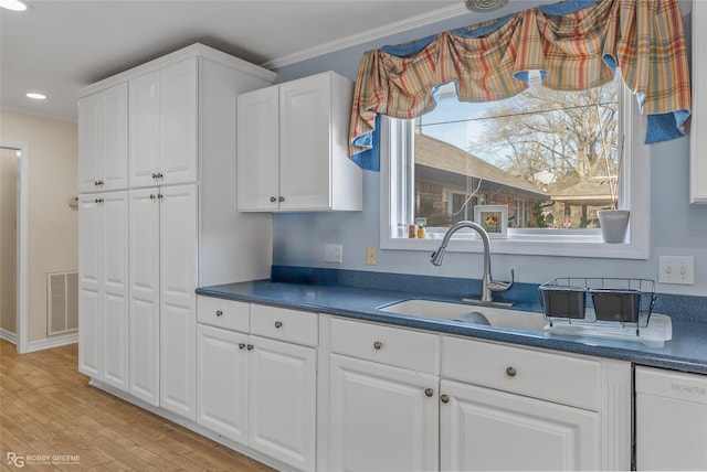 kitchen featuring sink, dishwasher, light hardwood / wood-style floors, white cabinets, and ornamental molding