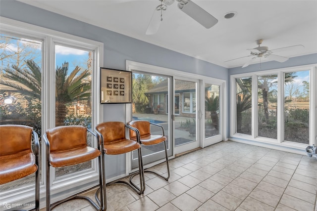 sunroom / solarium featuring ceiling fan