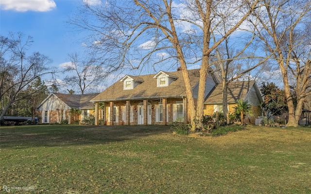 cape cod home featuring a front yard and a porch