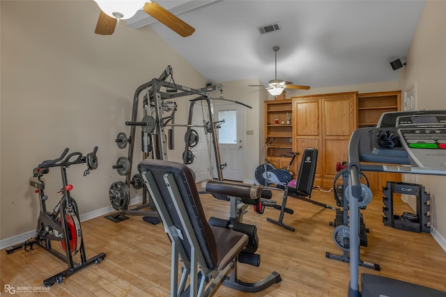 workout area featuring ceiling fan, light hardwood / wood-style flooring, and vaulted ceiling