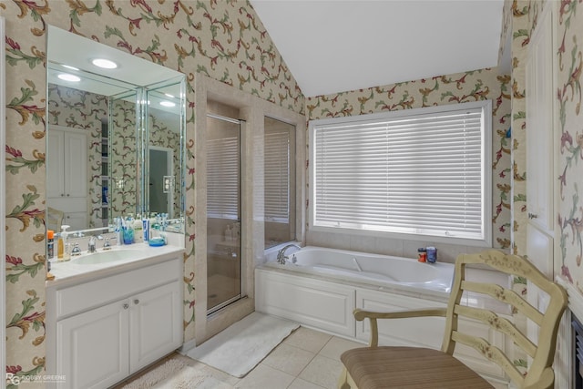 bathroom featuring vanity, vaulted ceiling, tile patterned floors, and walk in shower