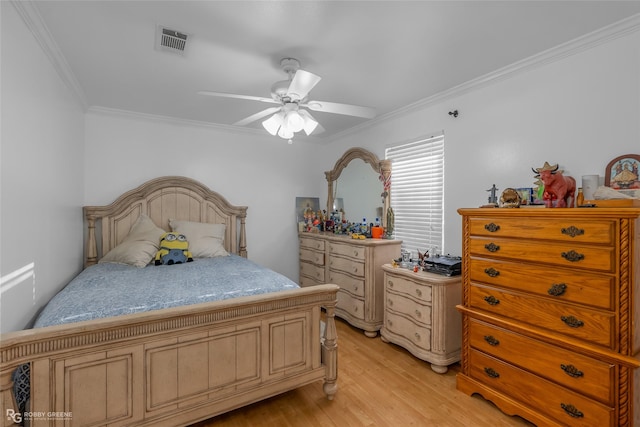 bedroom with ceiling fan, light hardwood / wood-style floors, and crown molding