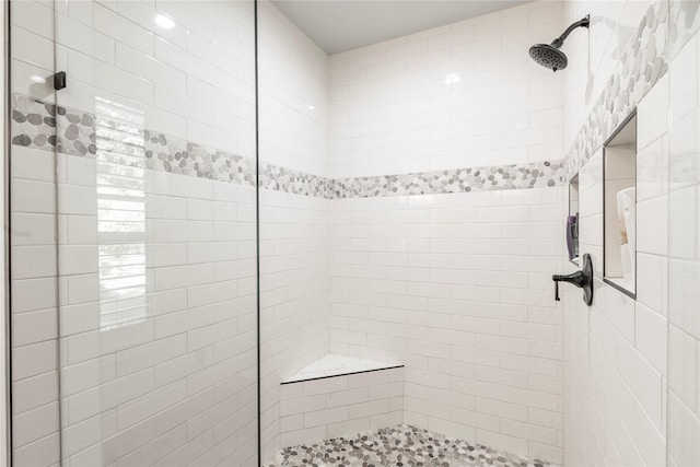 bathroom with a tile shower