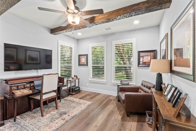 office area with light wood-type flooring, beamed ceiling, and ceiling fan