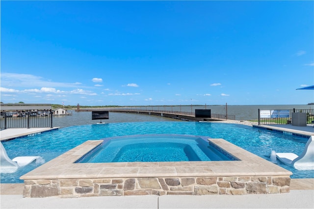 view of pool with an in ground hot tub and a water view